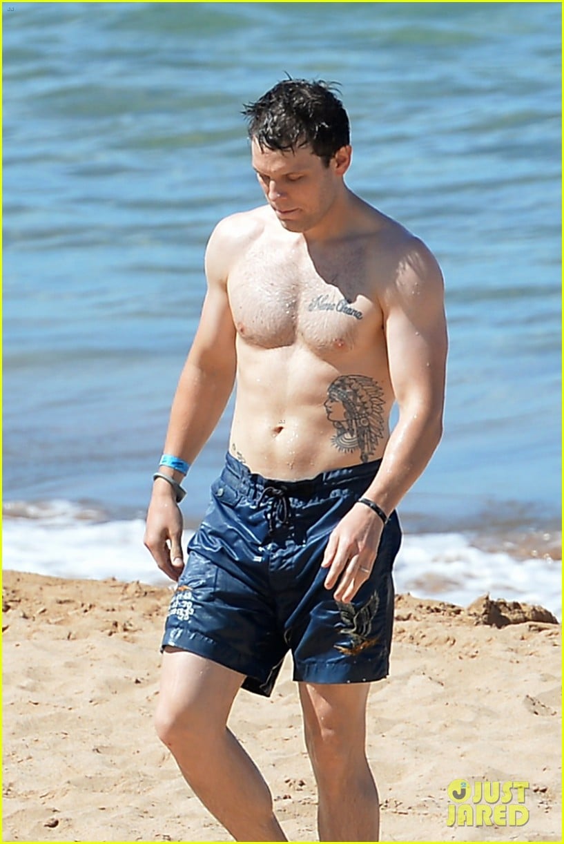 The Aquarius with shirtless athletic body on the beach
