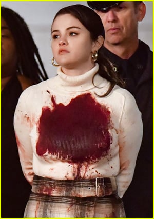 Selena Gomez bloody in a white top walked out by cops