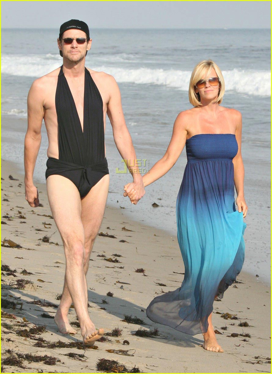 struts her stuff in a sexy black swimsuit while walking hand-in-hand with h...
