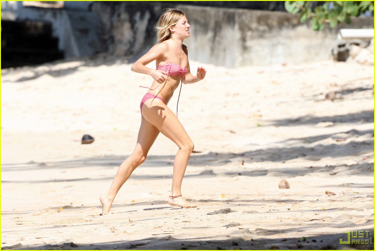Sienna Miller shows off her bikini body on the beach as she and some girlfr...