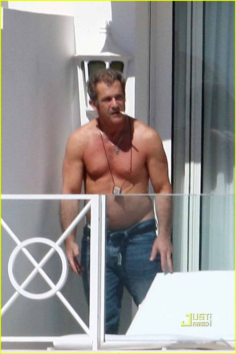 Mel Gibson goes shirtless on the balcony of his hotel on Tuesday (May 17) i...