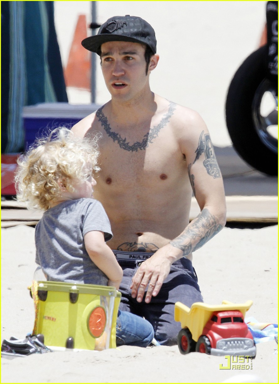 Pete Wentz goes shirtless at the beach while playing in the sand with his 2...