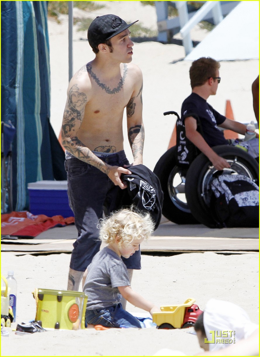 Pete Wentz goes shirtless at the beach while playing in the sand with his 2...