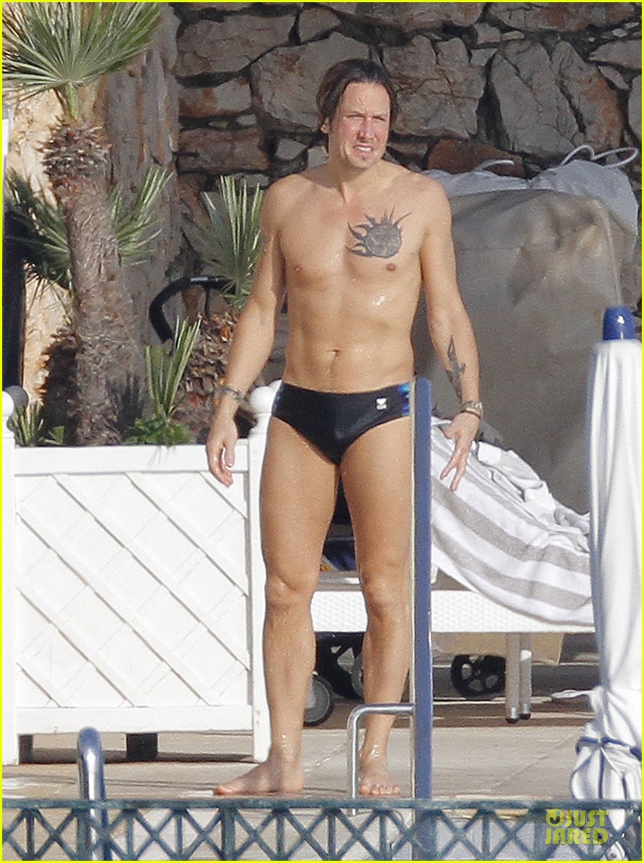 Keith Urban shows off his shirtless toned body in a speedo while swimming a...