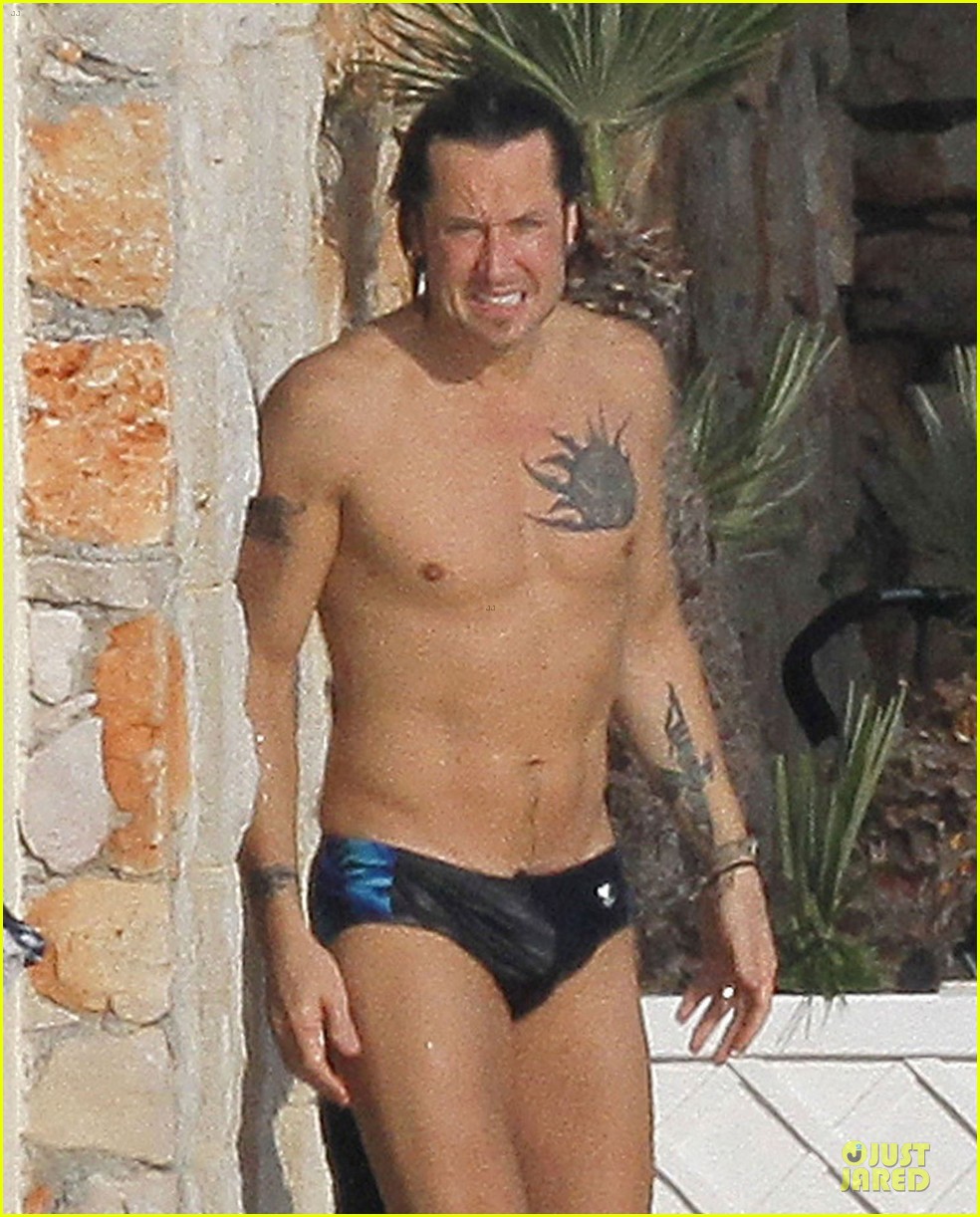 Keith Urban shows off his shirtless toned body in a speedo while swimming a...