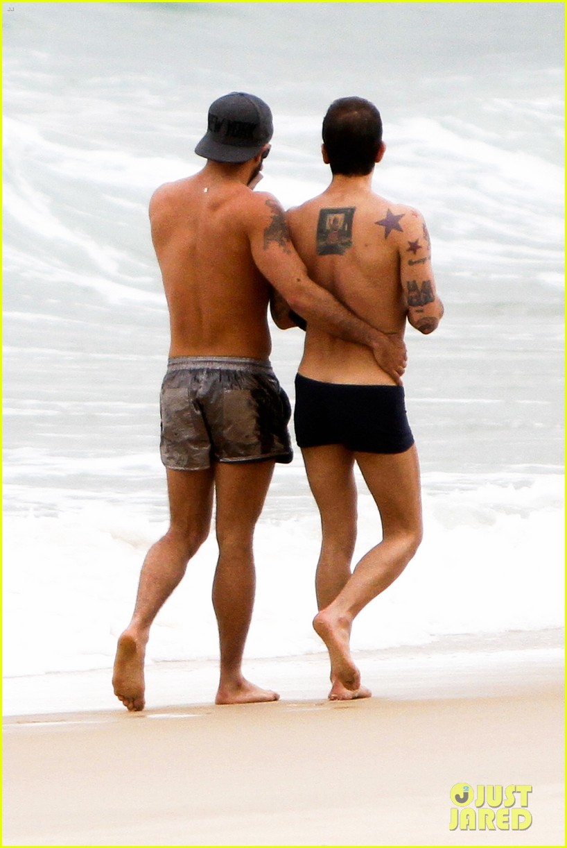 Marc Jacobs plants a sweet kiss on his boyfriend Harry Louis while relaxing...