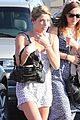 ashley greene shows white bra with overalls 02