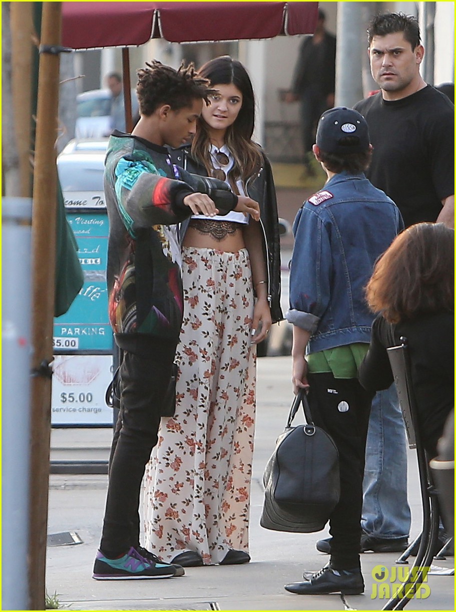 Jaden Smith puts his arms around Kylie Jenner and shows her an item while s...