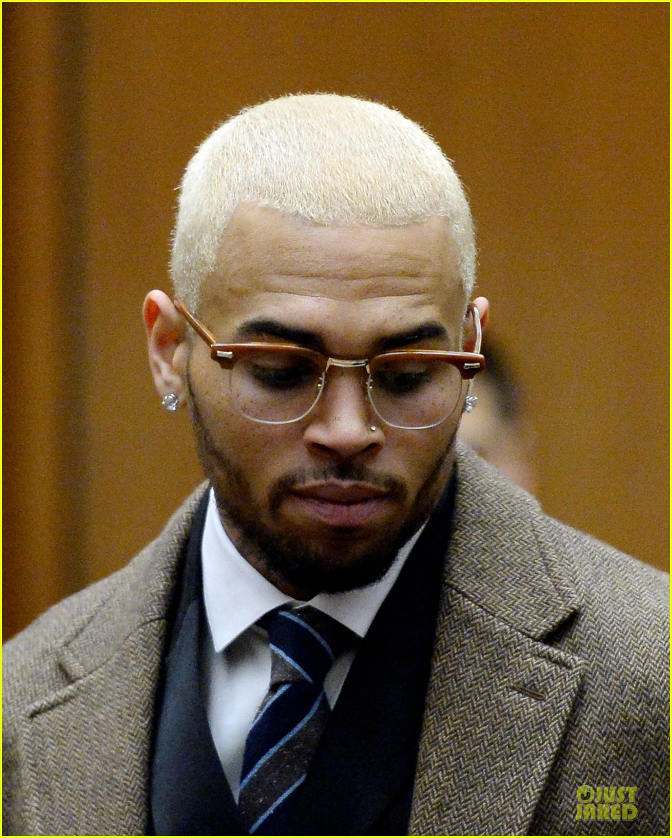 Chris Brown sports bleached blond hair while appearing in court with his at...