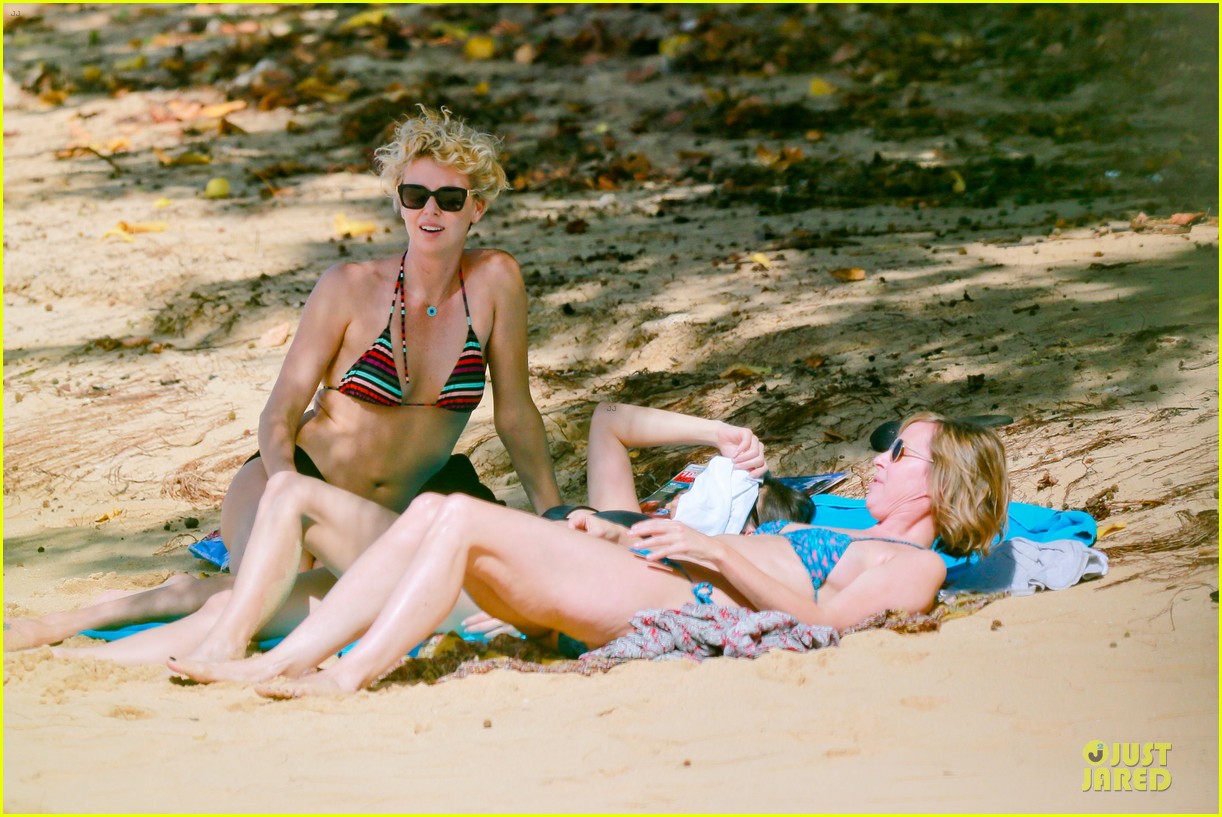 Charlize Theron shows off her rockin' bikini body while frolicking in ...