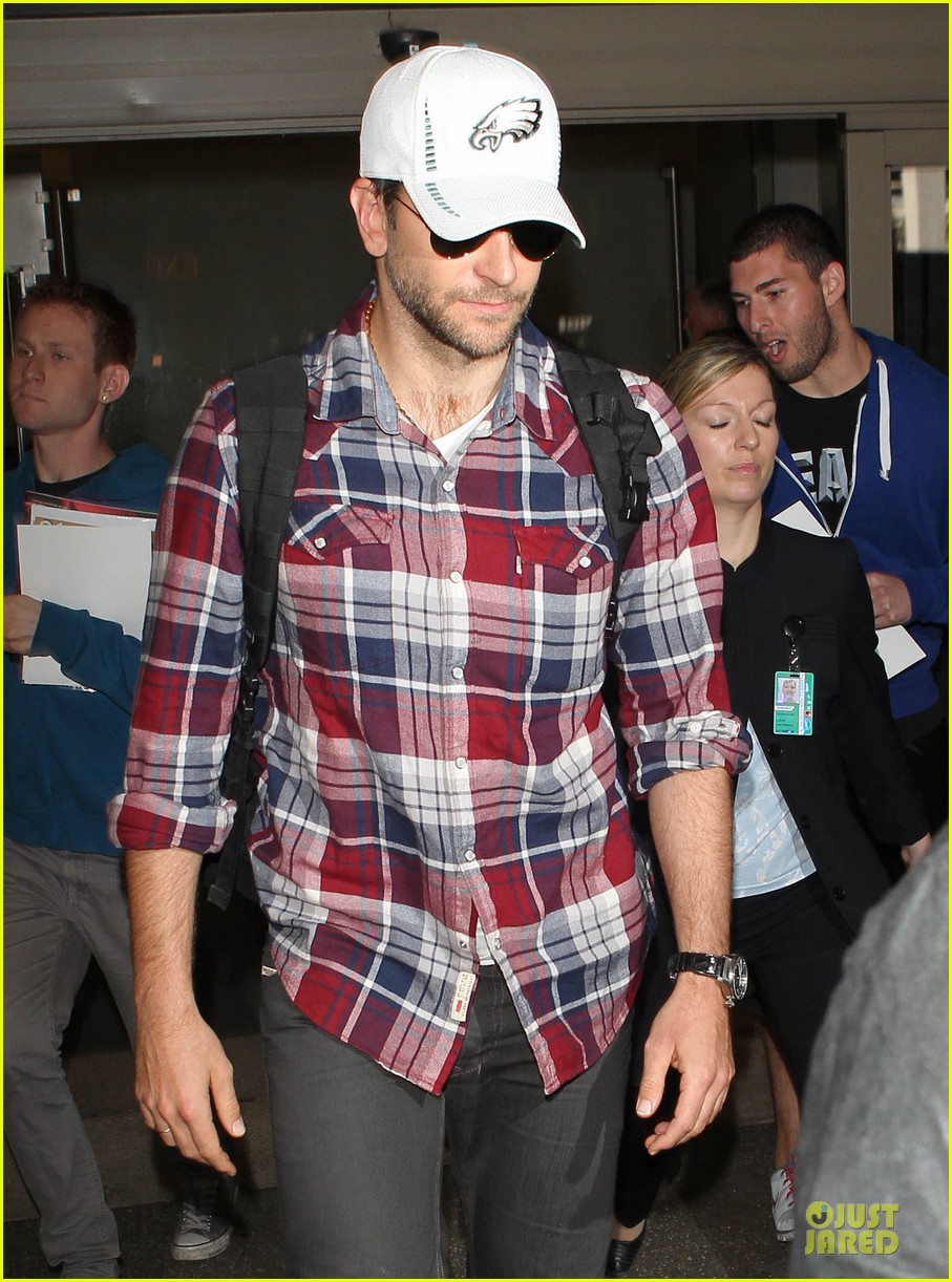 Photo: bradley cooper suki waterhouse lax arrival in the new year 07