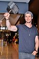 chris hemsworth carries thor hammer at narita airport 03