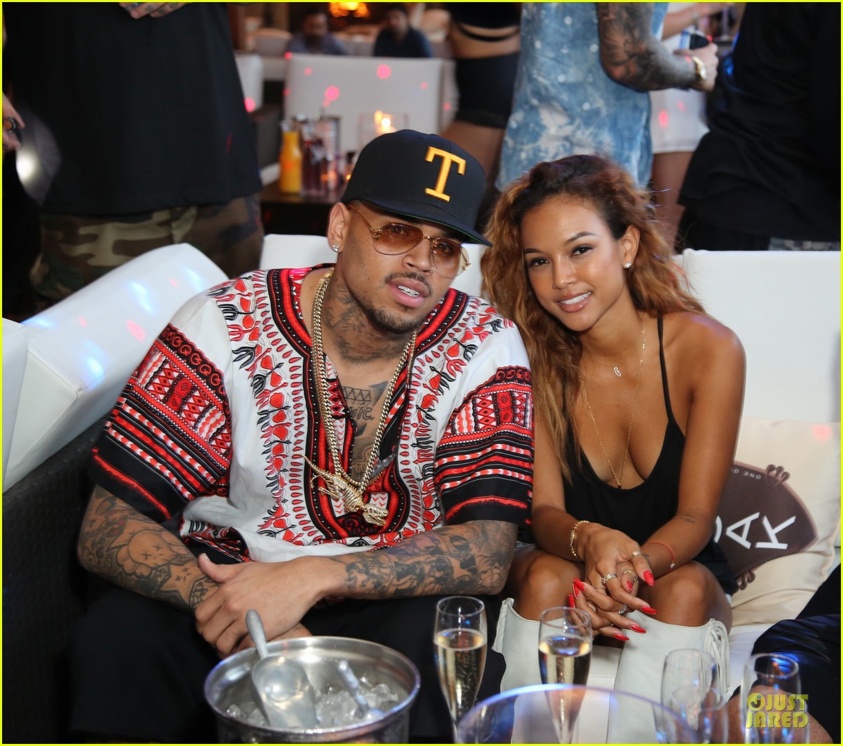 Chris Brown cozies up to his girlfriend Karrueche Tran during the 1OAK July...