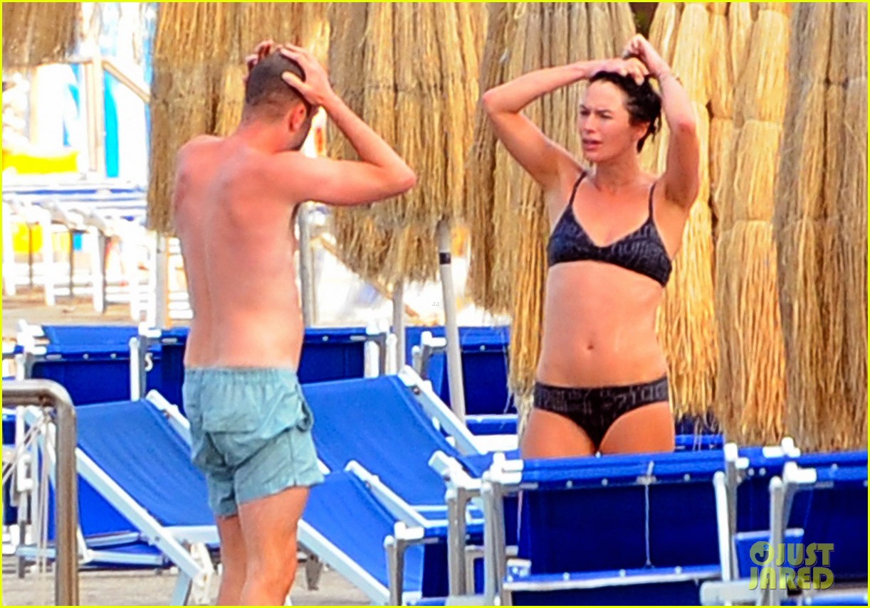 Lena Headey shows off her rock hard abs in a bikini while hanging by the wa...