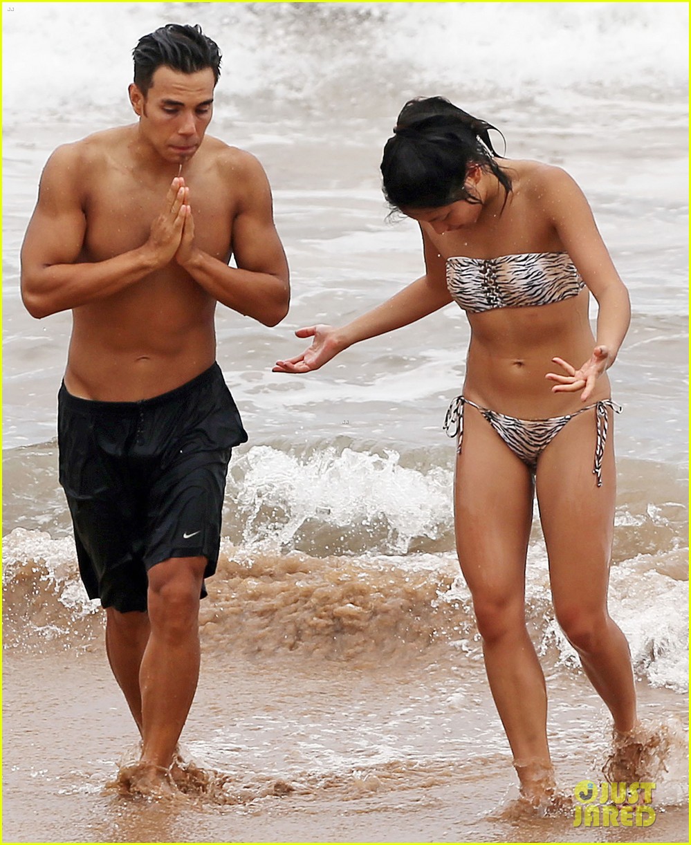 Apolo Ohno shows off his shirtless body while frolicking in the ocean with ...