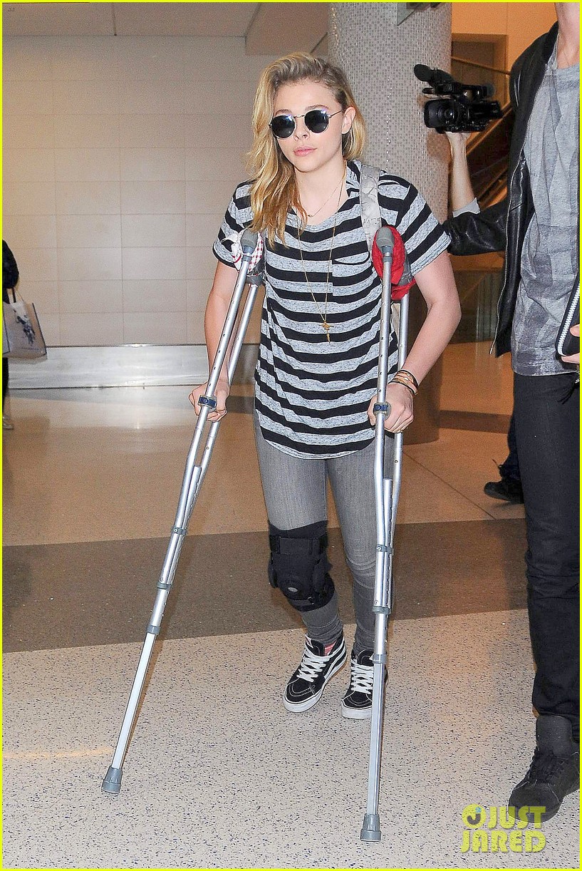 Chloe Moretz Wears Knee Brace & Uses Crutches at LAX Airport Photo