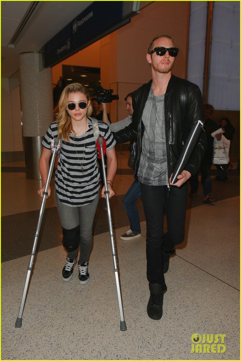 Chloe Moretz Wears Knee Brace & Uses Crutches at LAX Airport Photo