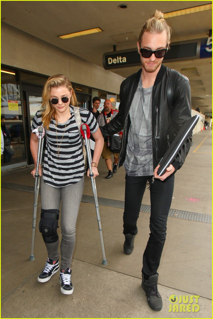 Chloe Moretz Wears Knee Brace & Uses Crutches at LAX Airport Photo