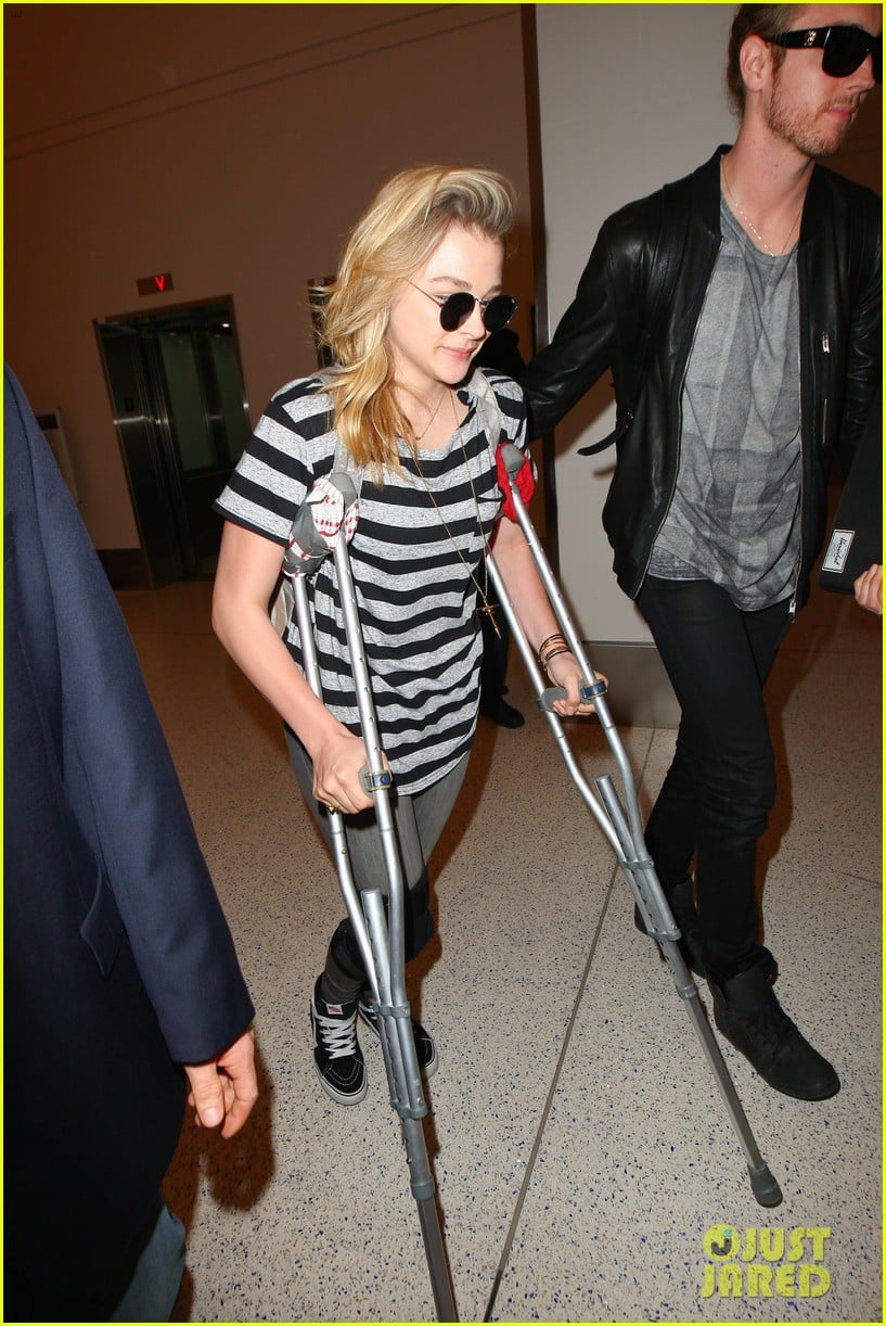 Chloe Moretz Wears Knee Brace & Uses Crutches at LAX Airport Photo
