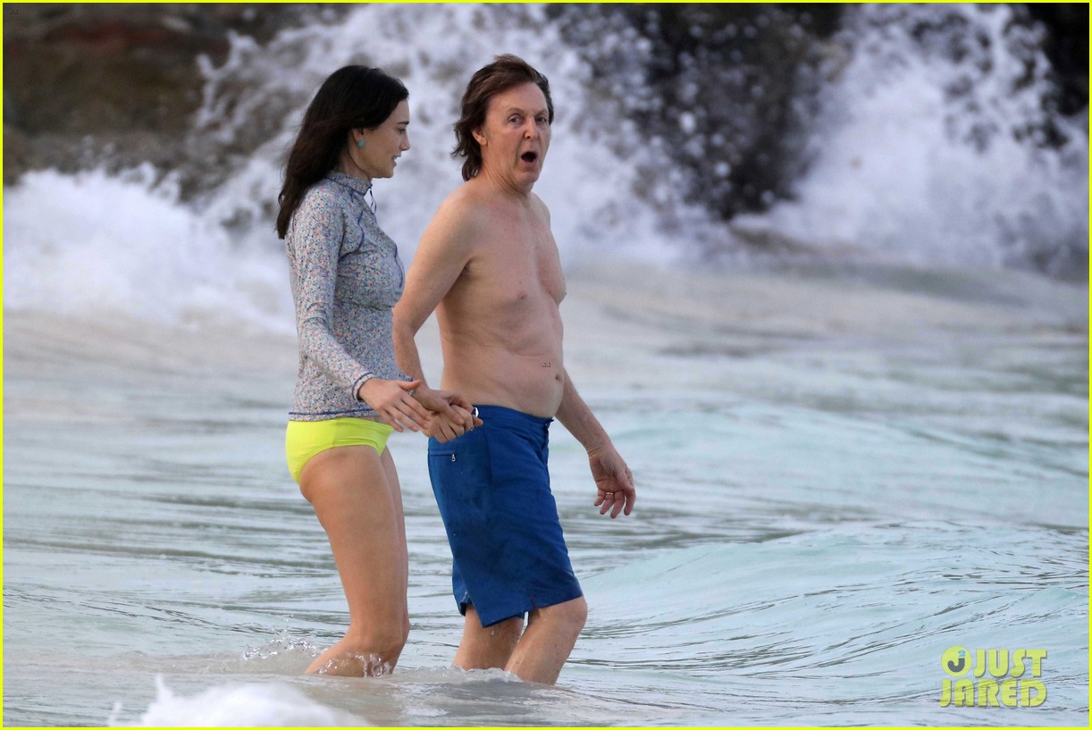 Paul McCartney is shocked by the cold as he makes his way inside the ocean ...