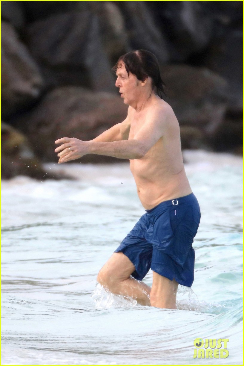 Paul McCartney is shocked by the cold as he makes his way inside the ocean ...