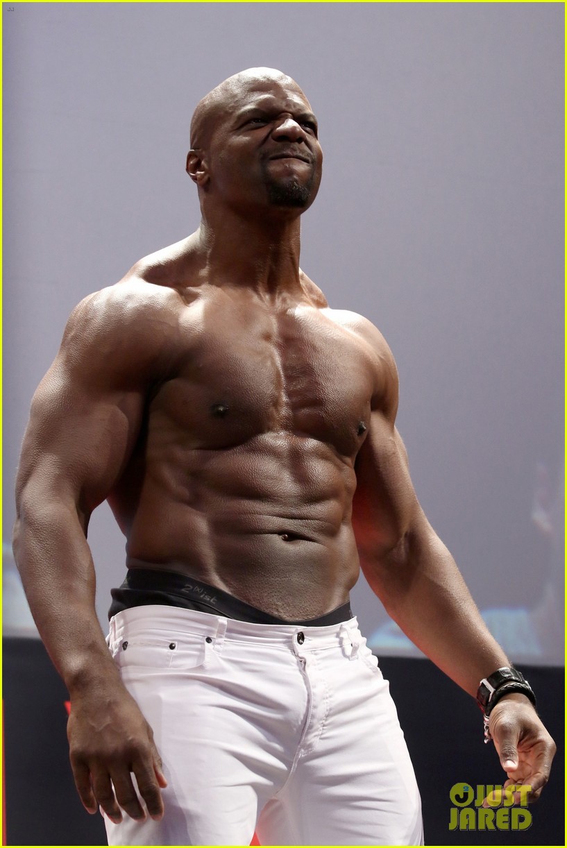 Terry Crews is chiseled from head-to-toe while sitting shirtless on stage a...
