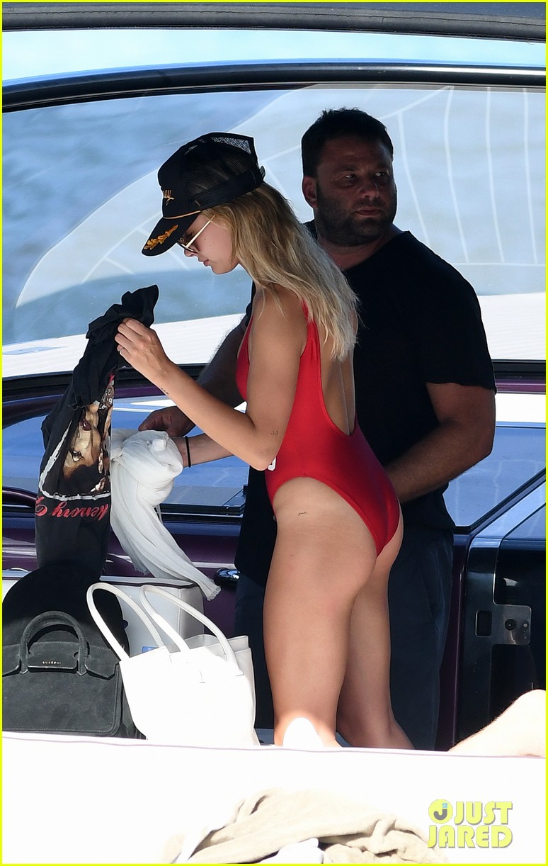 Hailey Baldwin looks hot in her red swimsuit while wearing a "just mar...