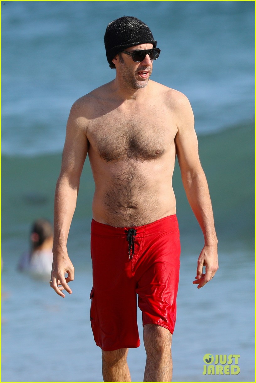 Isla Fisher Buries Sacha Baron Cohen in Sand at the Beach! Photo
