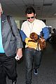 orlando bloom carries his cute dog through the airport 06