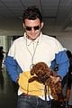 orlando bloom carries his cute dog through the airport 07