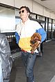 orlando bloom carries his cute dog through the airport 08