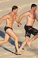 hugh jackman hits the beach with his speedo clad trainer 03