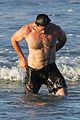 hugh jackman hits the beach with his speedo clad trainer 12