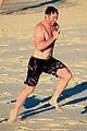 hugh jackman hits the beach with his speedo clad trainer 24