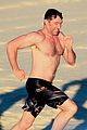 hugh jackman hits the beach with his speedo clad trainer 30