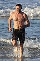 hugh jackman hits the beach with his speedo clad trainer 49