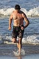 hugh jackman hits the beach with his speedo clad trainer 50