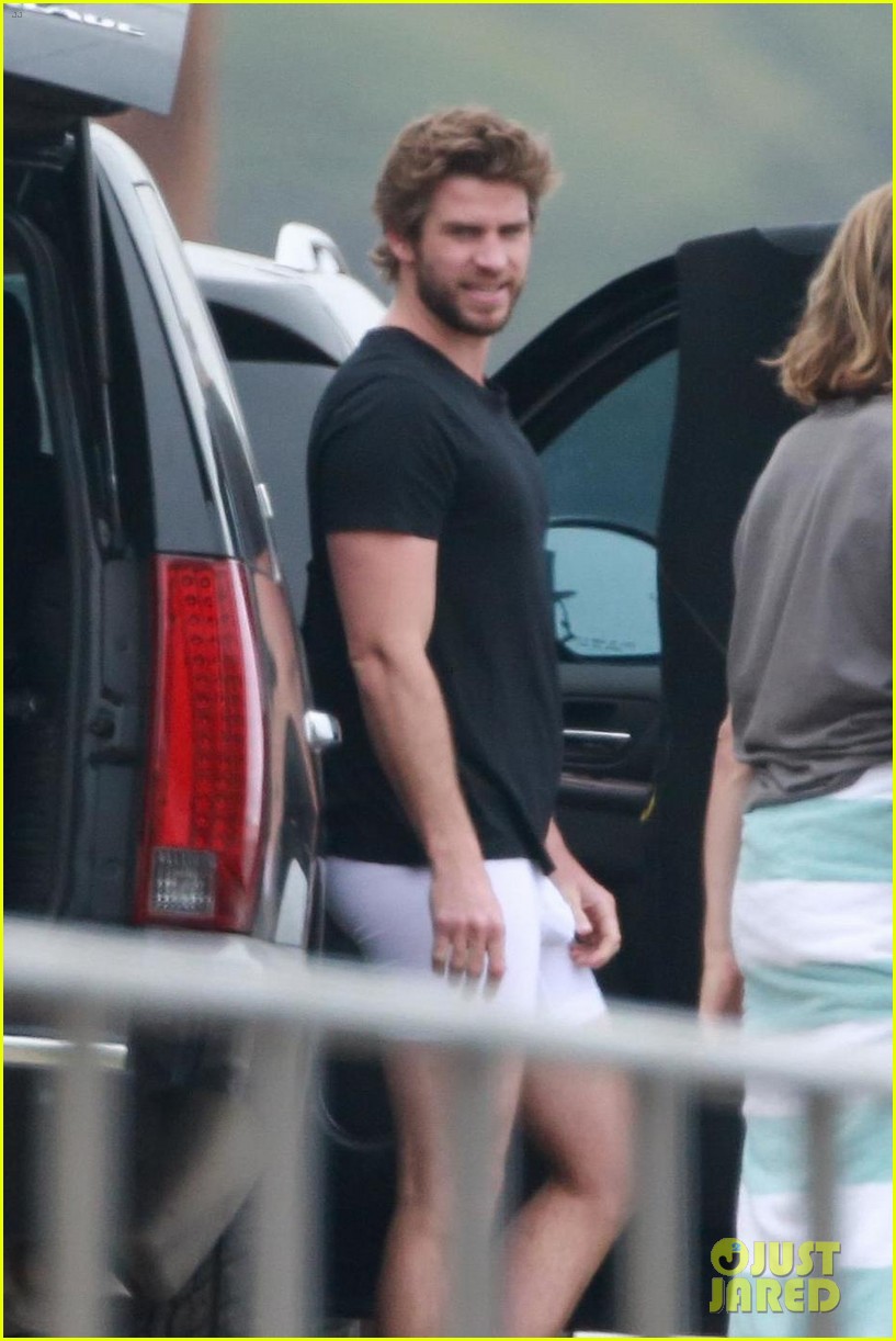 Liam Hemsworth shows off his hot shirtless body while hitting the beach to ...