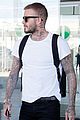 david beckham puts his tattoos on display while arriving in barcelona02