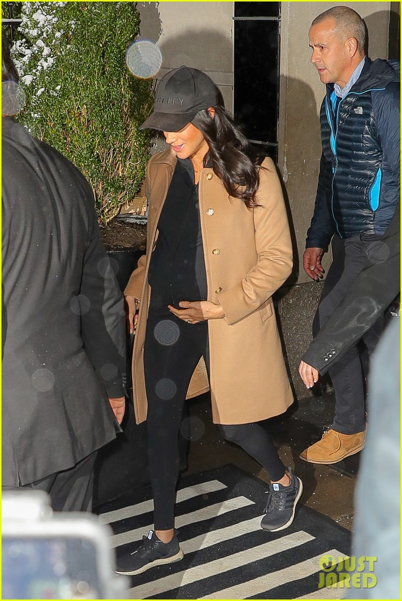 Meghan Markle Cradles Her Baby Bump While Departing NYC After Her Baby