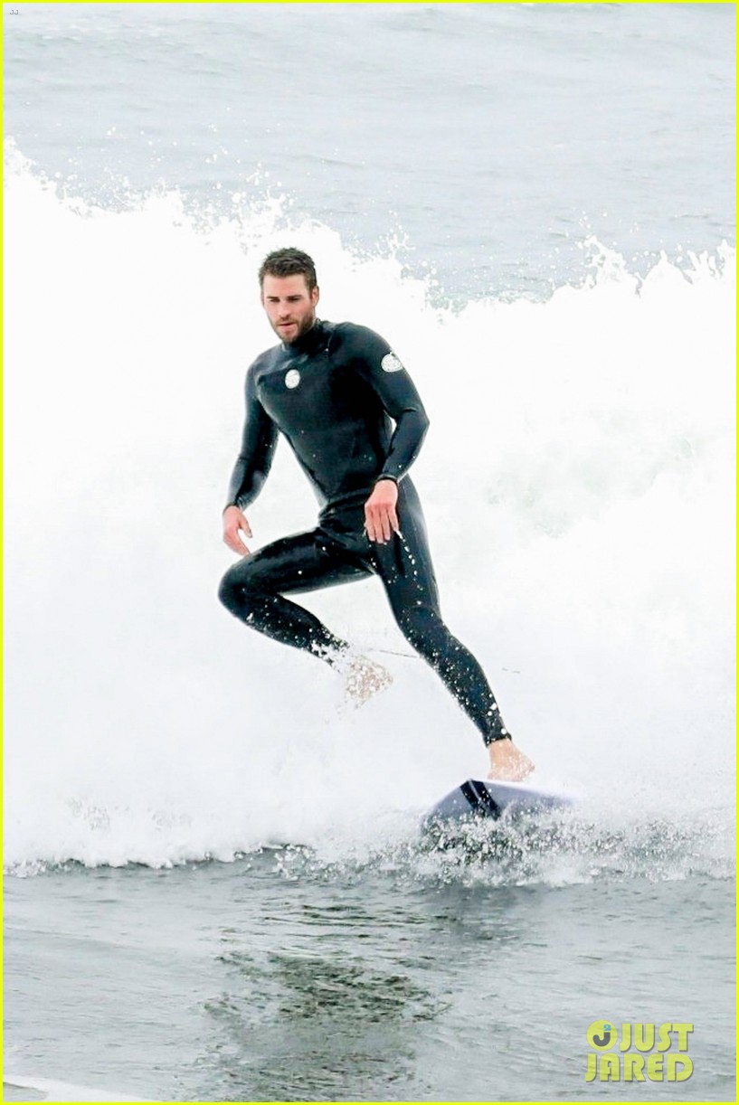 Liam Hemsworth Strips Out of His Wetsuit After a Surf Session Photo