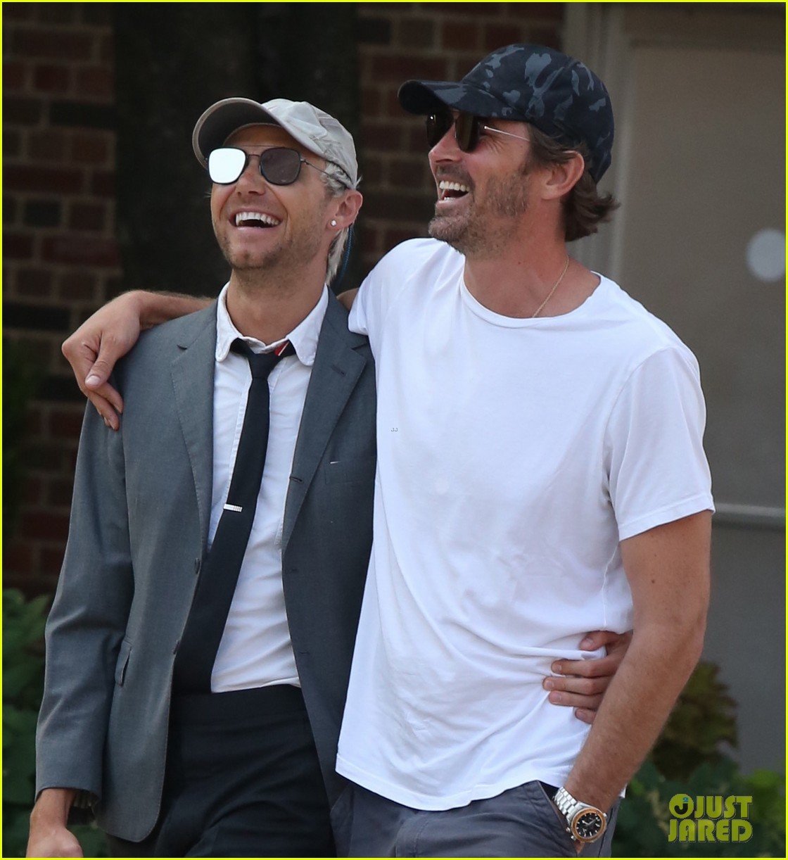 Lee Pace wraps his arm around boyfriend Matthew Foley while going for a str...