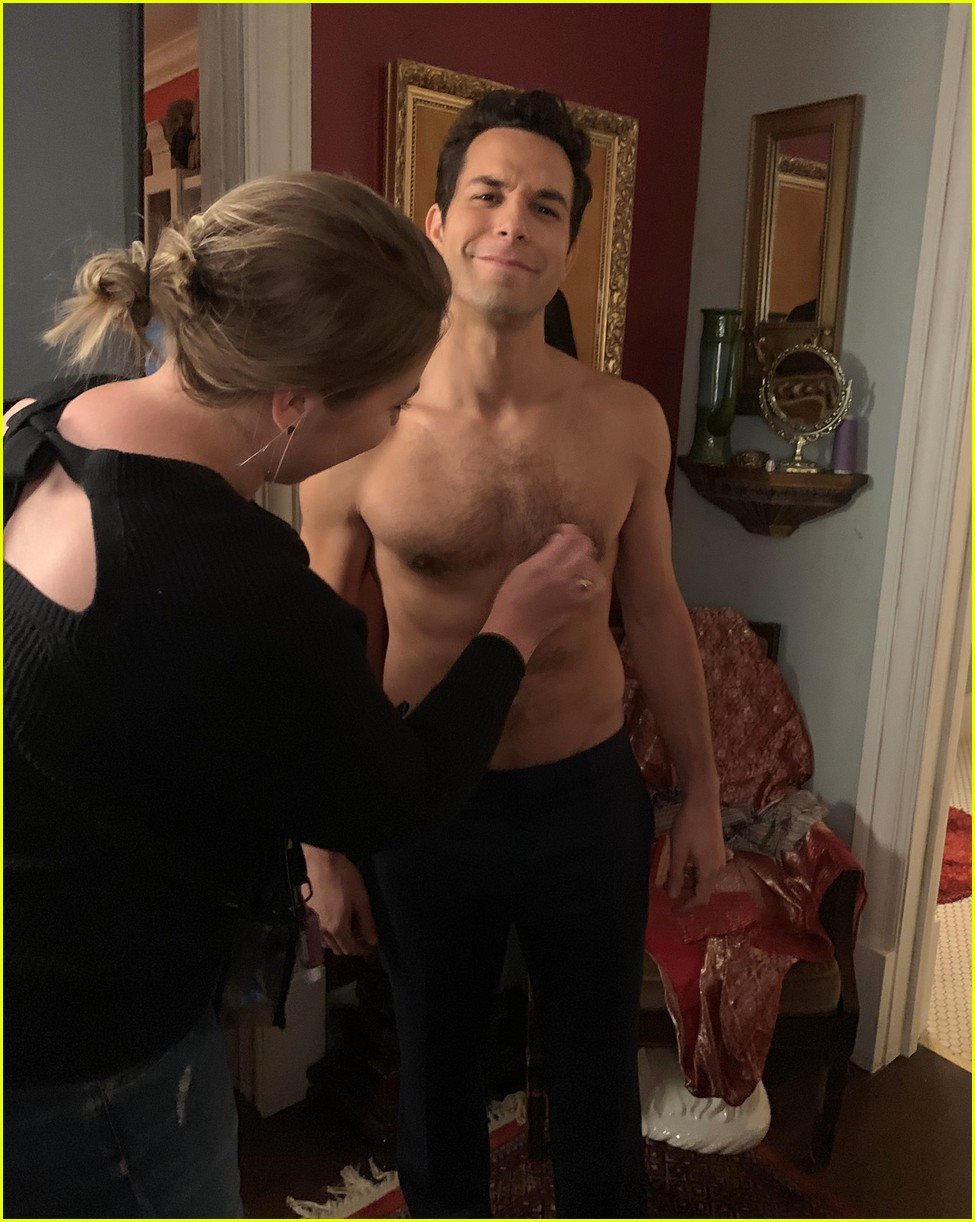 Skylar Astin shows off his ripped body and flexes his bicep during a shirtl...