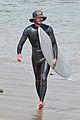 adam brody goes surfing in his wetsuit 01