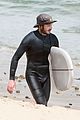 adam brody goes surfing in his wetsuit 04