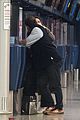 lily james dominic west hug airport 01
