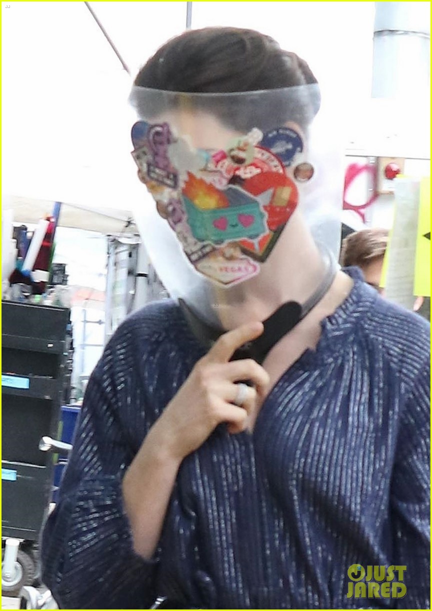 anne hathaway wears face shield covered with stickers on wecrashed set 024575109