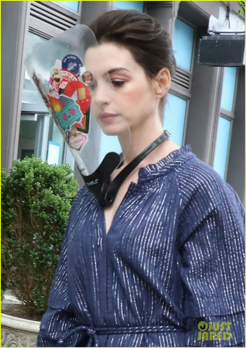 anne hathaway wears face shield covered with stickers on wecrashed set 034575110