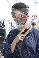 anne hathaway wears face shield covered with stickers on wecrashed set 02