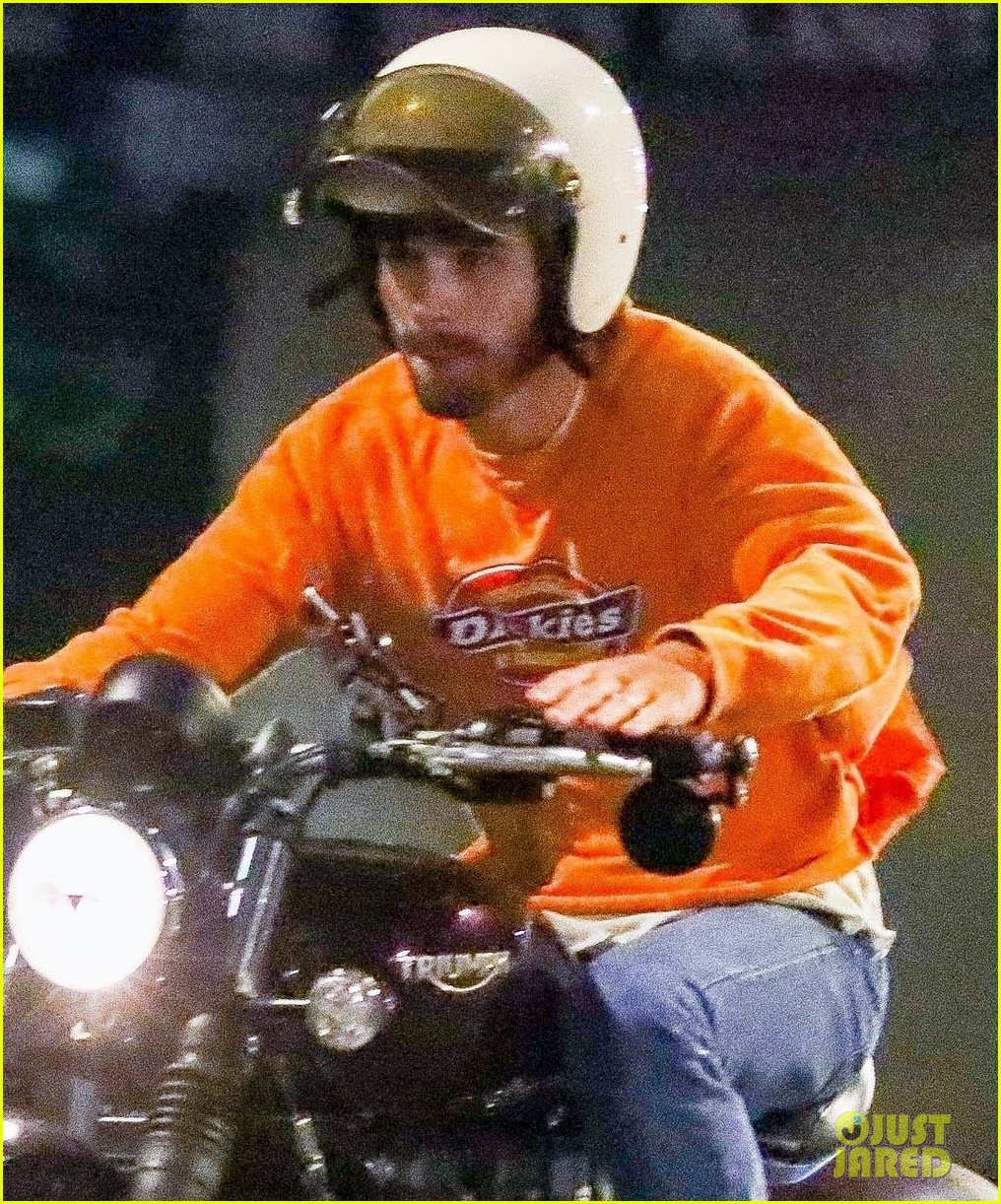 kj apa rides his motorcycle to dinner with friends 034595212